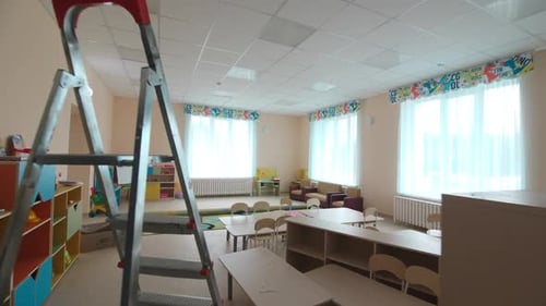 Empty Classroom with Tables and Chairs