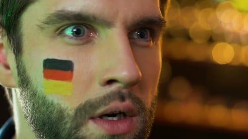 Close-Up Of Anxious Man With Painted Flag Shouting