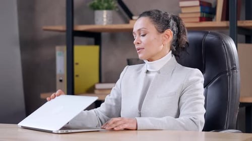 Woman Meditating at Desk in Office