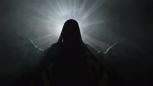 Hooded Figure in Dark, Illuminated by Light