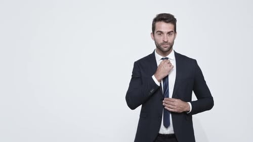 Young Adult Adjusting Tie in Business Suit