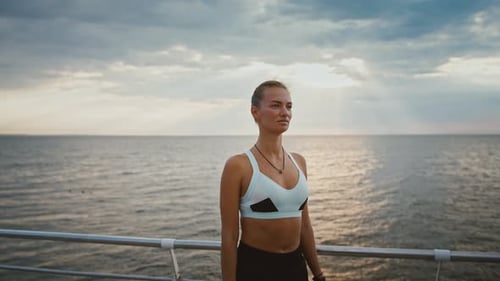 Outdoor Portrait of Young Sportive Disabled Woman Standing on Pier