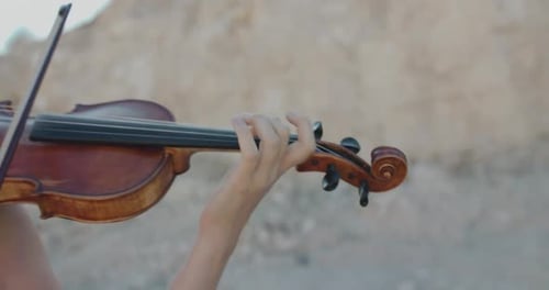 Young Woman Playing Violin Outside