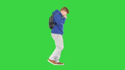 School Boy in Casual Clothes Walking and Taking Off Medical Mask on a Green Screen, Chroma Key