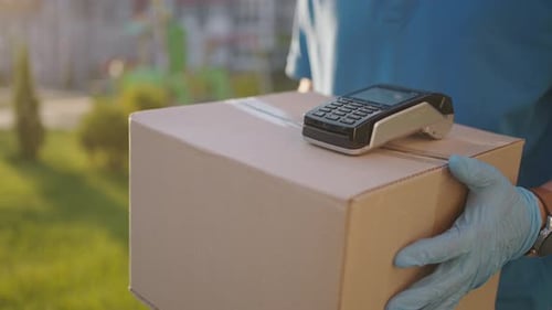 Postman or Delivery Man Carry Small Box Deliver to Customer at Home Contactless Nfc Terminal Payment