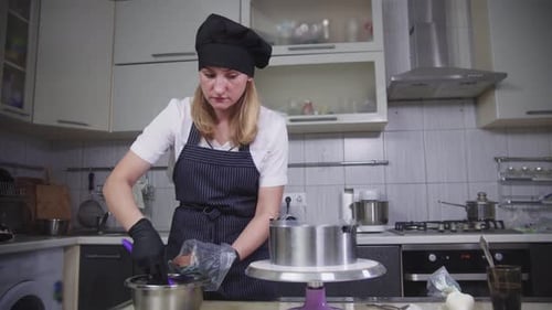 Confectionery a Woman Puts Chocolate Cream in Pastry Bag
