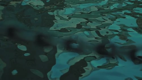 Metallic Chain in Rippling, Blue-Green Water