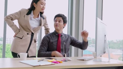 Two Business People Talk Project Strategy at Office