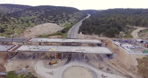 Aerial footage of a large scale highway construction project with tunnels and bridges