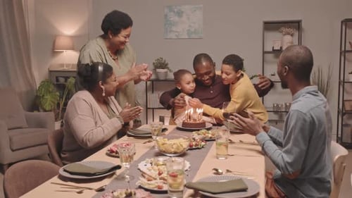 Family Celebrating Birthday at Home with Cake