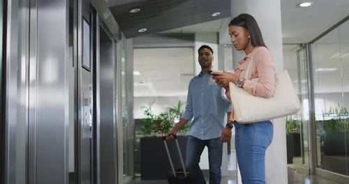 Adults Waiting for Elevator in Modern Office Building