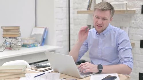 Man Working at Desk With Neck Pain