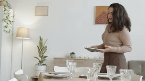 Woman Prepares Elegant Dining Table Setting at Home