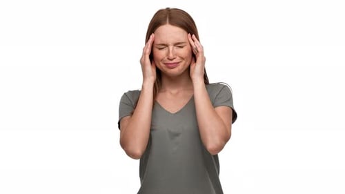 Young Woman Massaging Temples in Discomfort