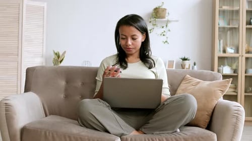 Woman Shopping Online with Laptop at Home
