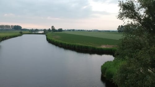 Rural landscape river and closeby flying near natural trees, aerial drone view