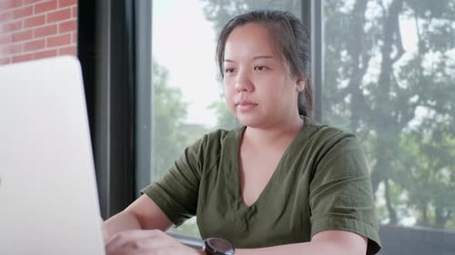Woman Working on Laptop in Home Office