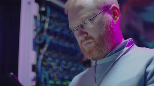 Data Center Worker Using Tablet in Server Room