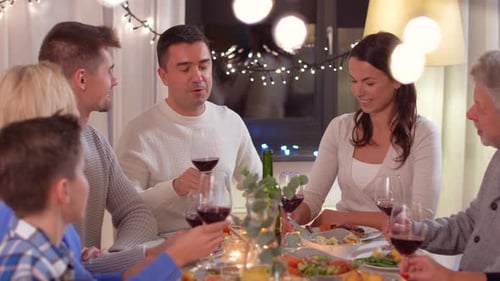 Family Celebrates and Toasts With Red Wine