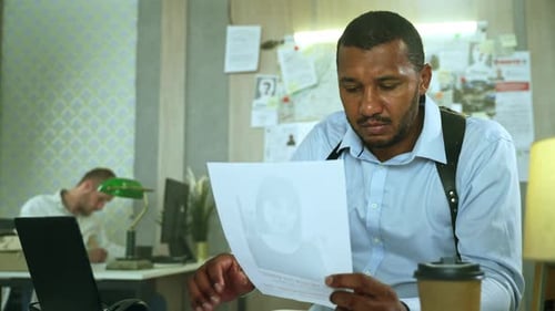 Detective Examining Evidence in Urban Office