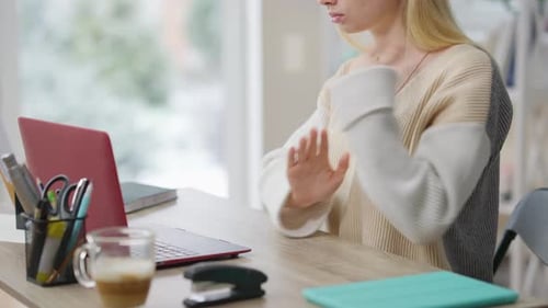 Young Adult Uses Sign Language at Desk