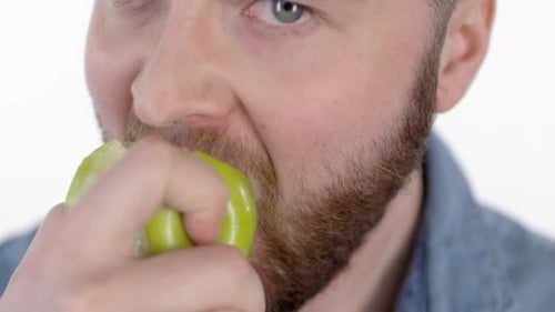 Young Man Eating Green Apple
