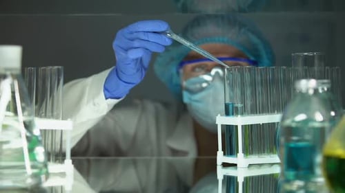 Scientist Uses Pipette to Extract Sample in Lab