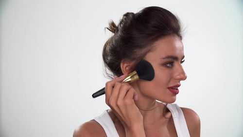 Beauty Face Makeup. Woman Applying Blush On Skin With Brush