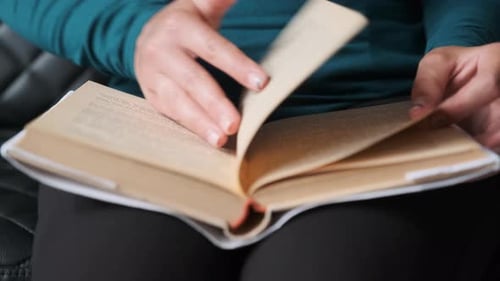 Young Woman Reading Book. Close-up Book Reading