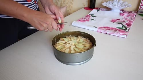 Woman Prepares Apple Cake in the Kitchen