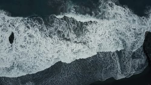 Aerial Top View of Ocean Waves Breaking on Dark Rocks on Black Sand Beach, Canary Islands, Tenerife