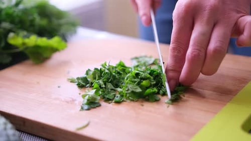 Chef Chopping Fresh Herbs on Cutting Board