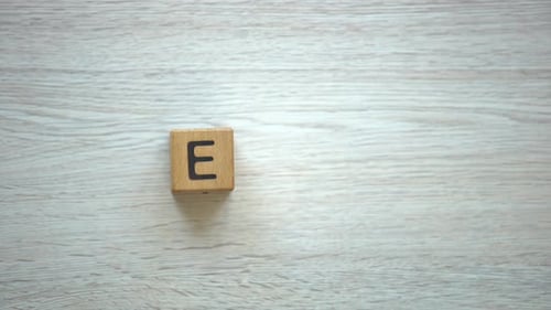 Hand Arranges Letter Blocks Spelling ECO