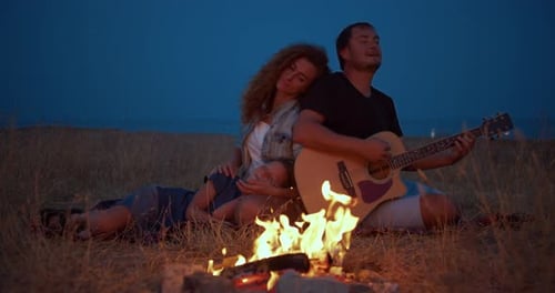 Daddy Plays Guitar , Mom with Son Enjoy While Relaxing on Family Picnic Near Bonfire. Close-up