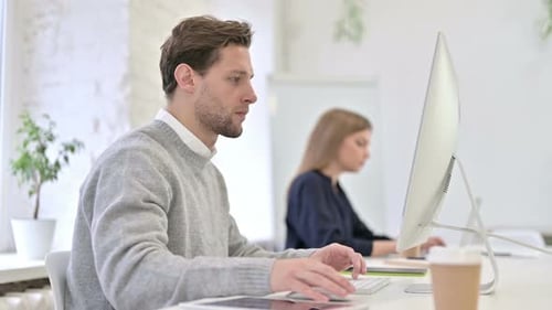 Adult Man Talking and Typing in Office