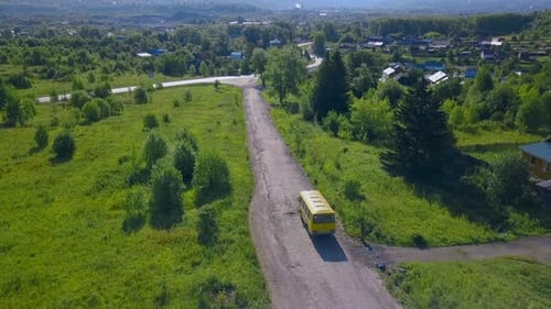 A long highway with cars around the forest
