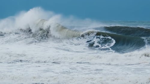 Big Wave with Foam and Dirt Breaks on the Shore During Strong Storm in the Atlantic Ocean