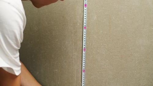 Man Builder Using Roulette Wheel and Drawing Line Closeup