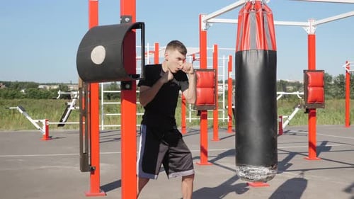 Street fighter. Boxer. Boxing. Punching boxing bag