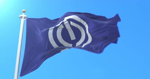Waving Flag with Abstract Circular Symbol Against Blue Sky