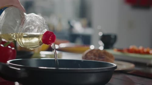 Cooking Oil Poured Into Frying Pan on Stove