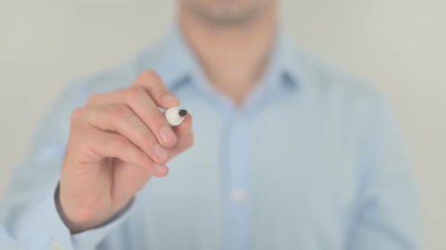 Man Writes the Word Debt on Clear Surface