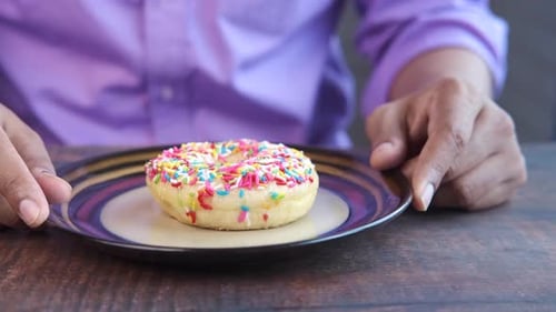 Close Up of Hand Holding Donuts