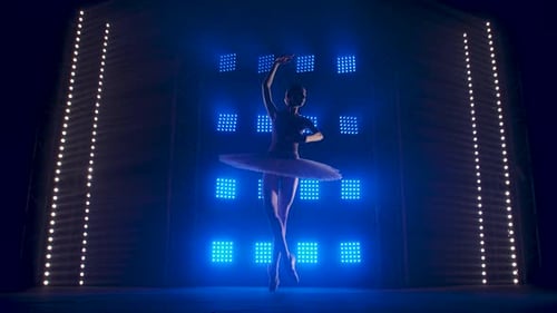 Ballerina Performs on Stage with Striking Lighting