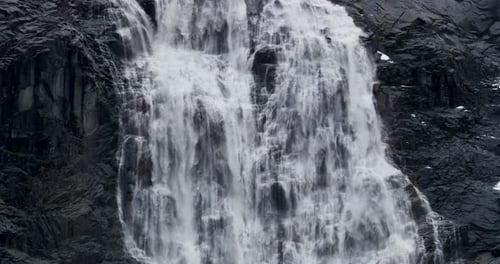 Waterfall Cascading Down Rocky Cliffside in Nature