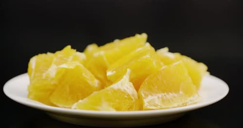 Extreme Close Up of Sliced Orange Rotating on Plate