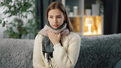 Woman with Sore Throat and Coughing at Home