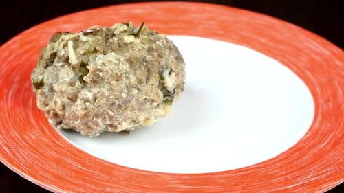Adding Delicious Meatballs with Creamy Sauce to Plate