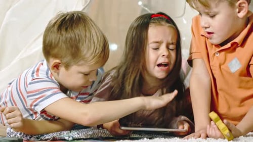 Children Using Tablet in Cozy Indoor Tent