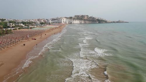 Aerial view of amazing beach with colorful umbrellas and turquoise sea